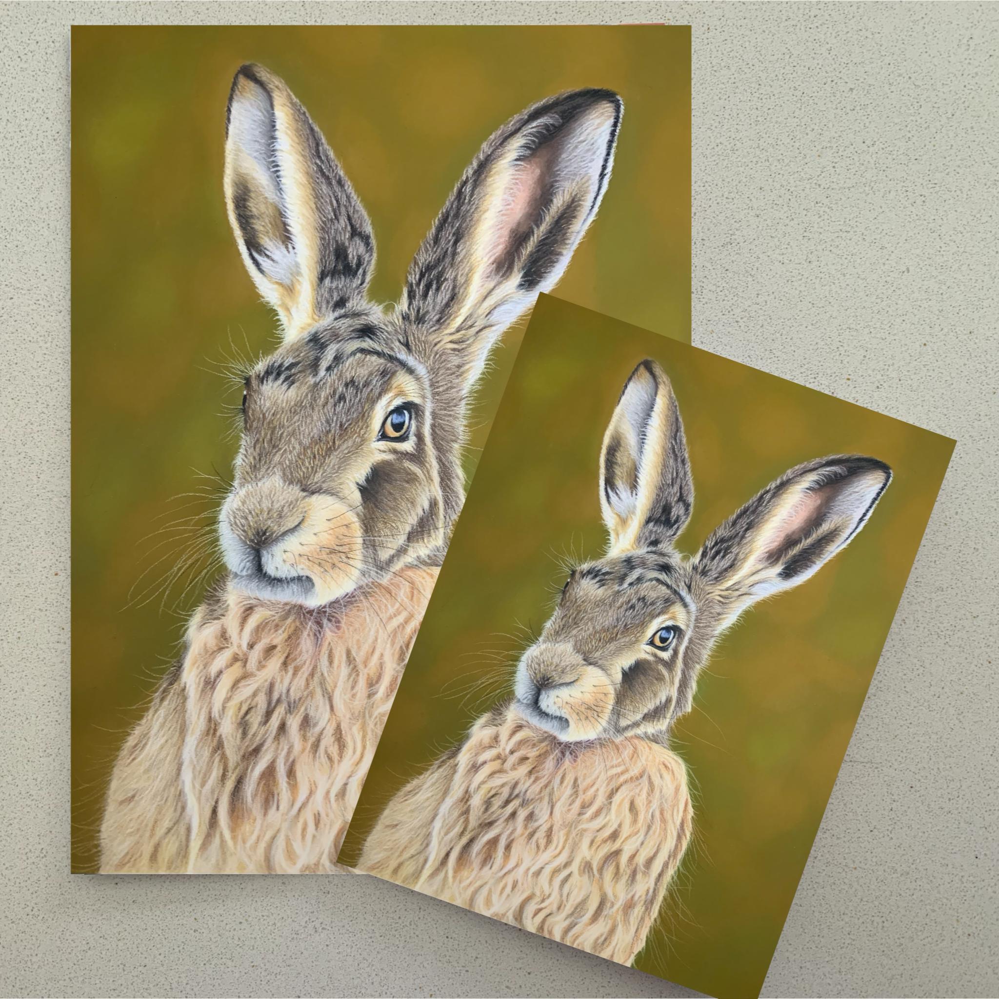 Two cards with hare illustrations on a green background