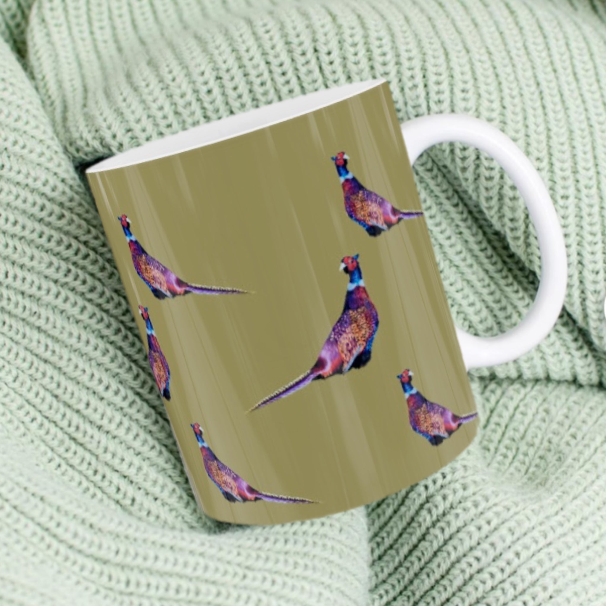 11oz ceramic mug with game birds illustration against sage green background