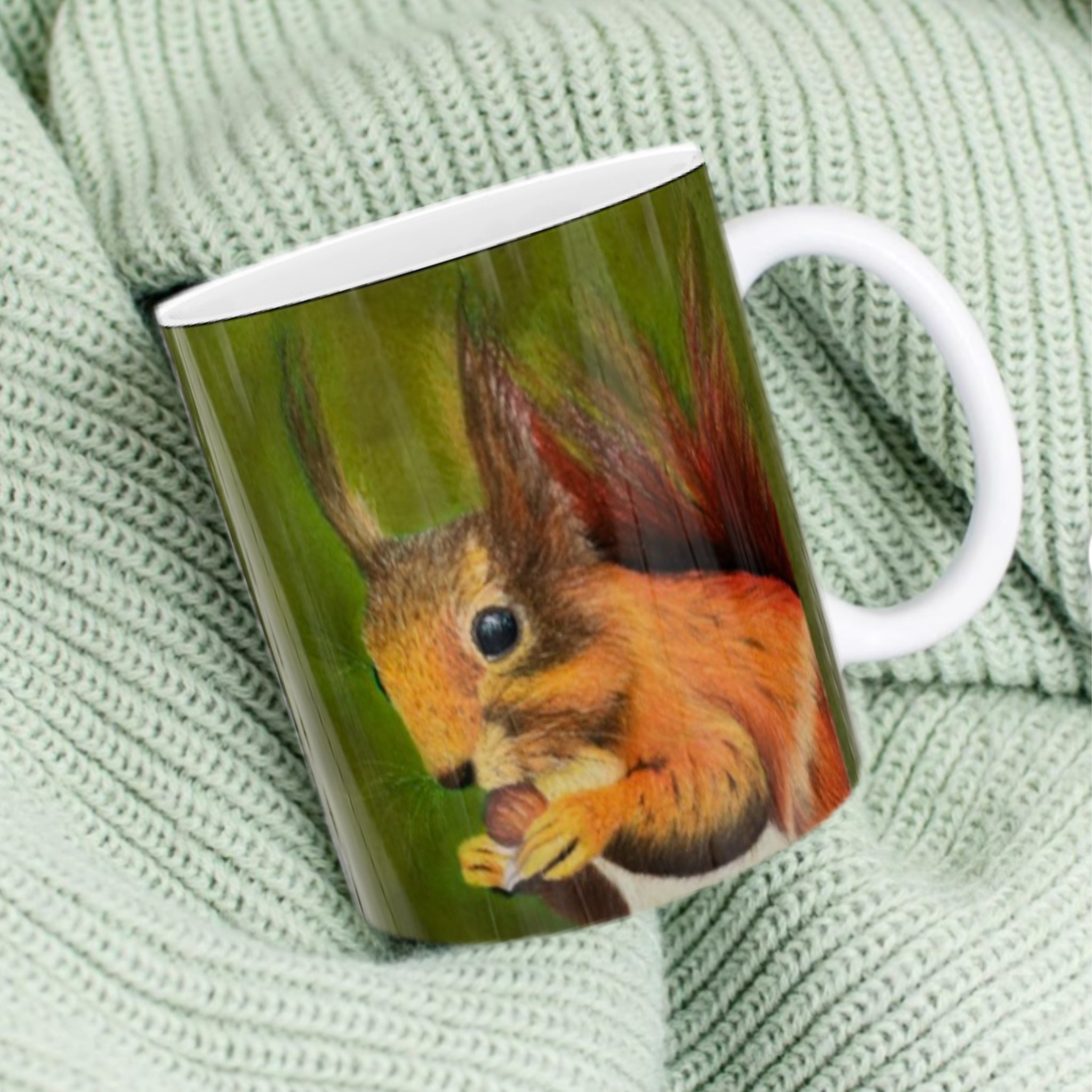 11oz ceramic mug with red squirrel illustration against olive green background