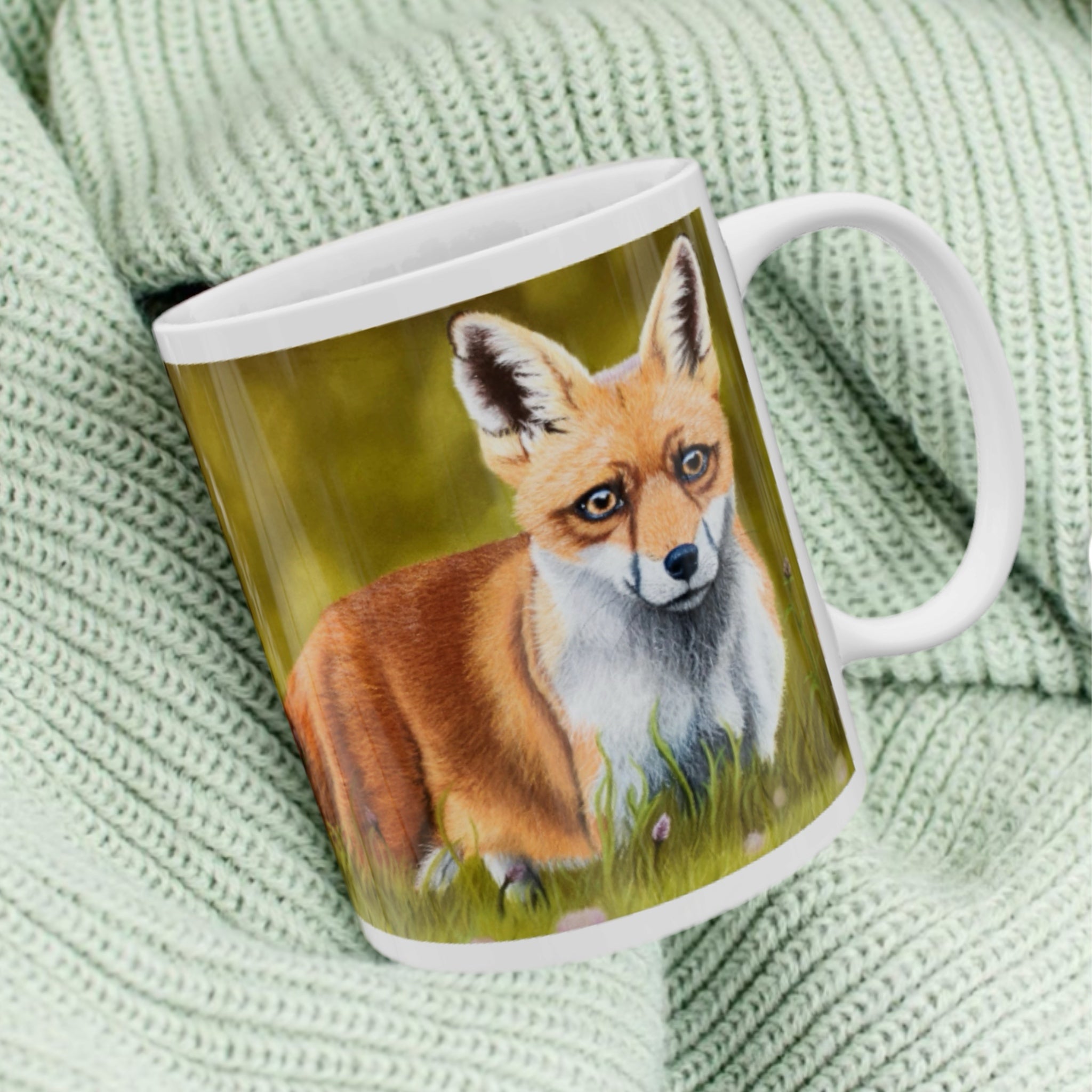 11oz ceramic mug with fox illustration against green woodland background