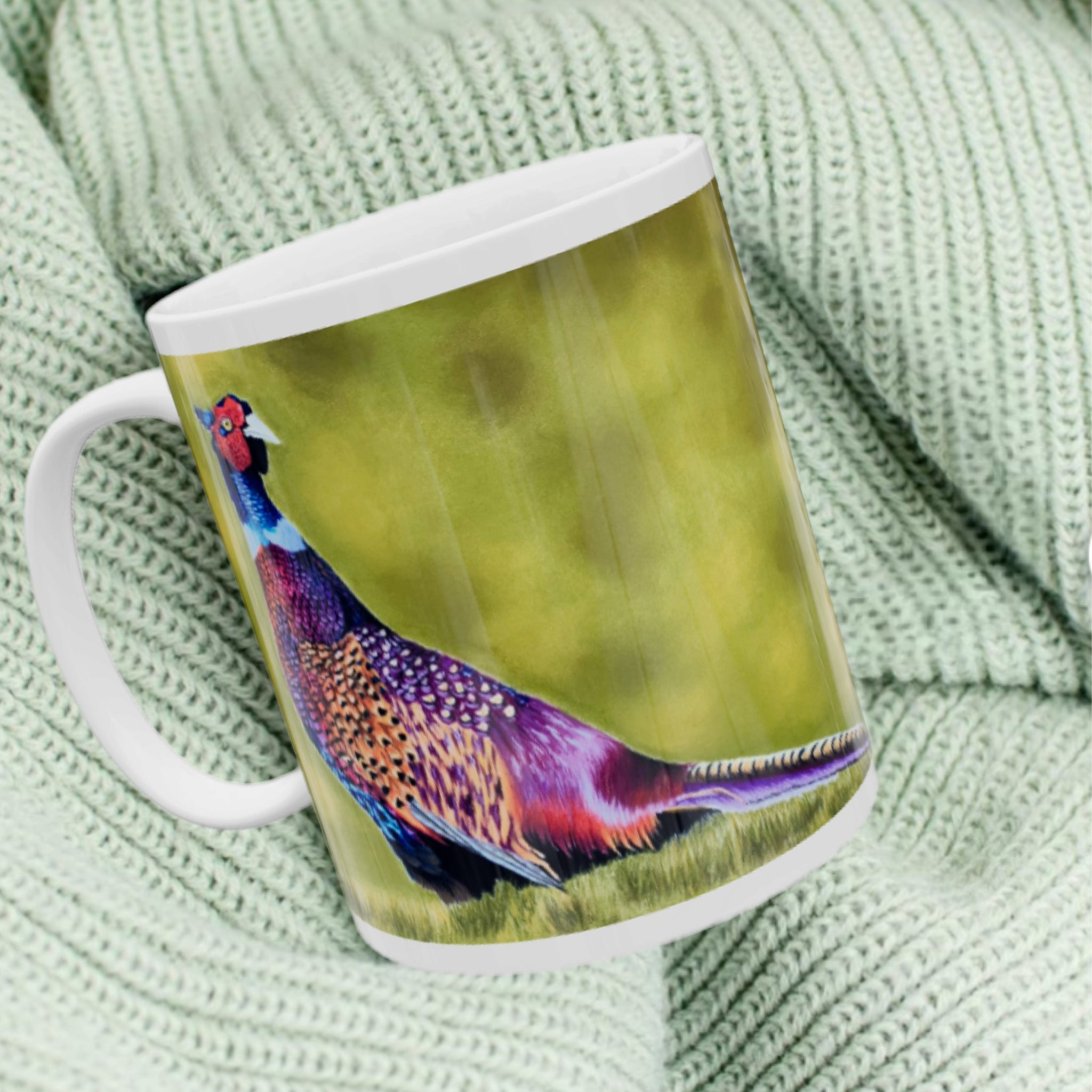 11oz ceramic mug with a colourful pheasant illustration against green woodland background