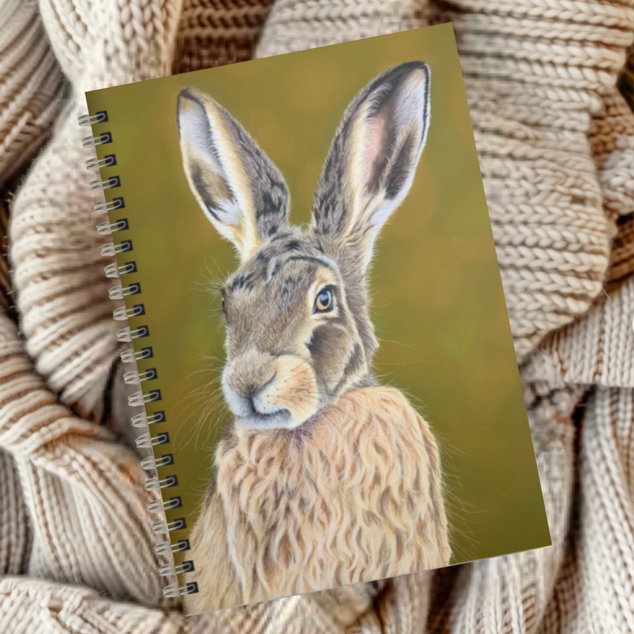 Notebook with a hare illustration on green background