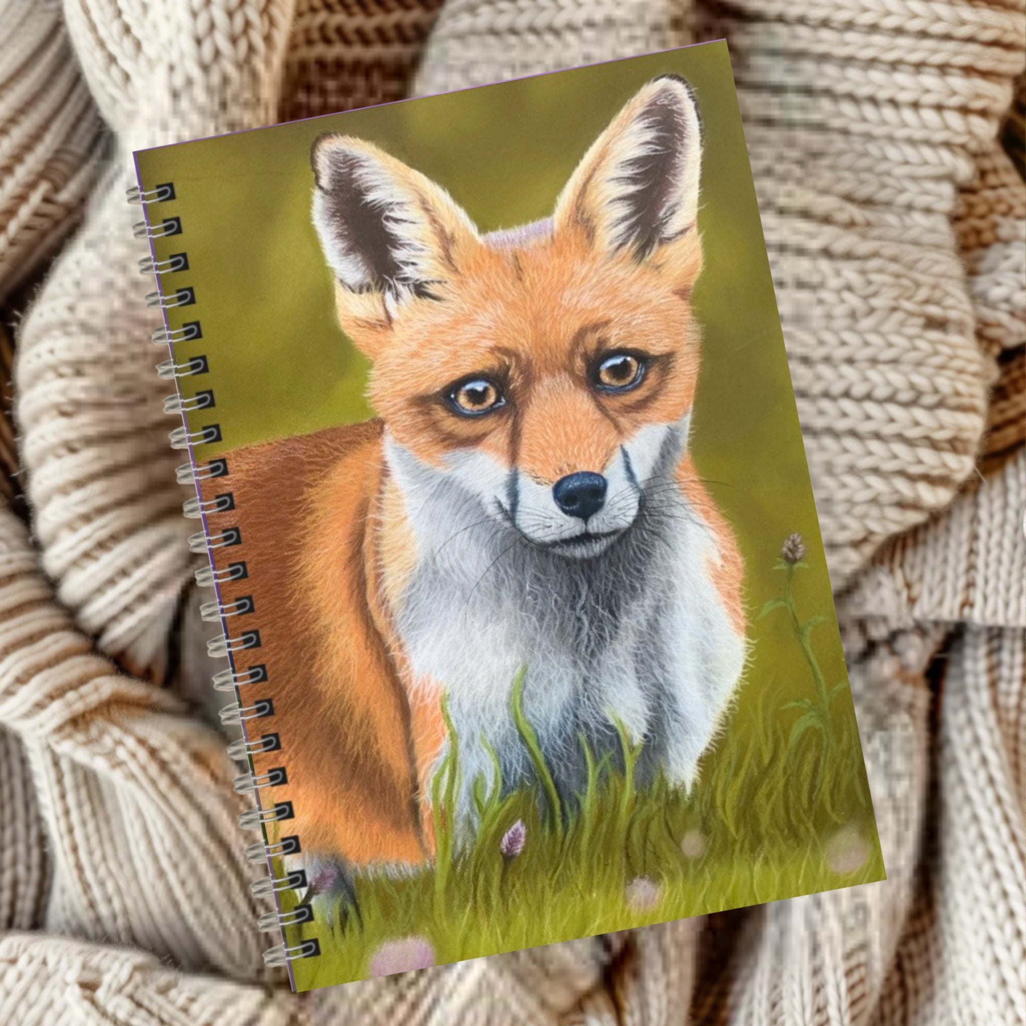 Notebook with a fox illustration on a green background