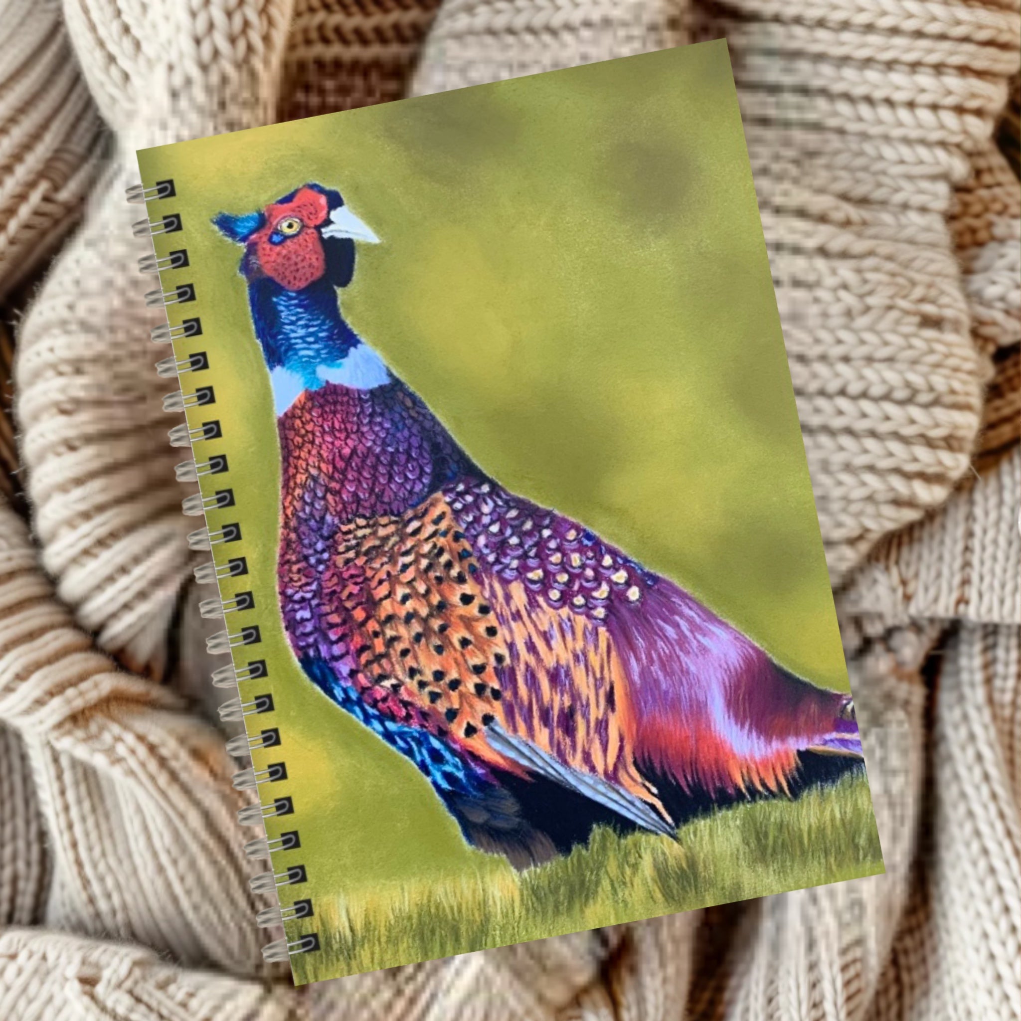 Notebook with a colourful pheasant design and green background