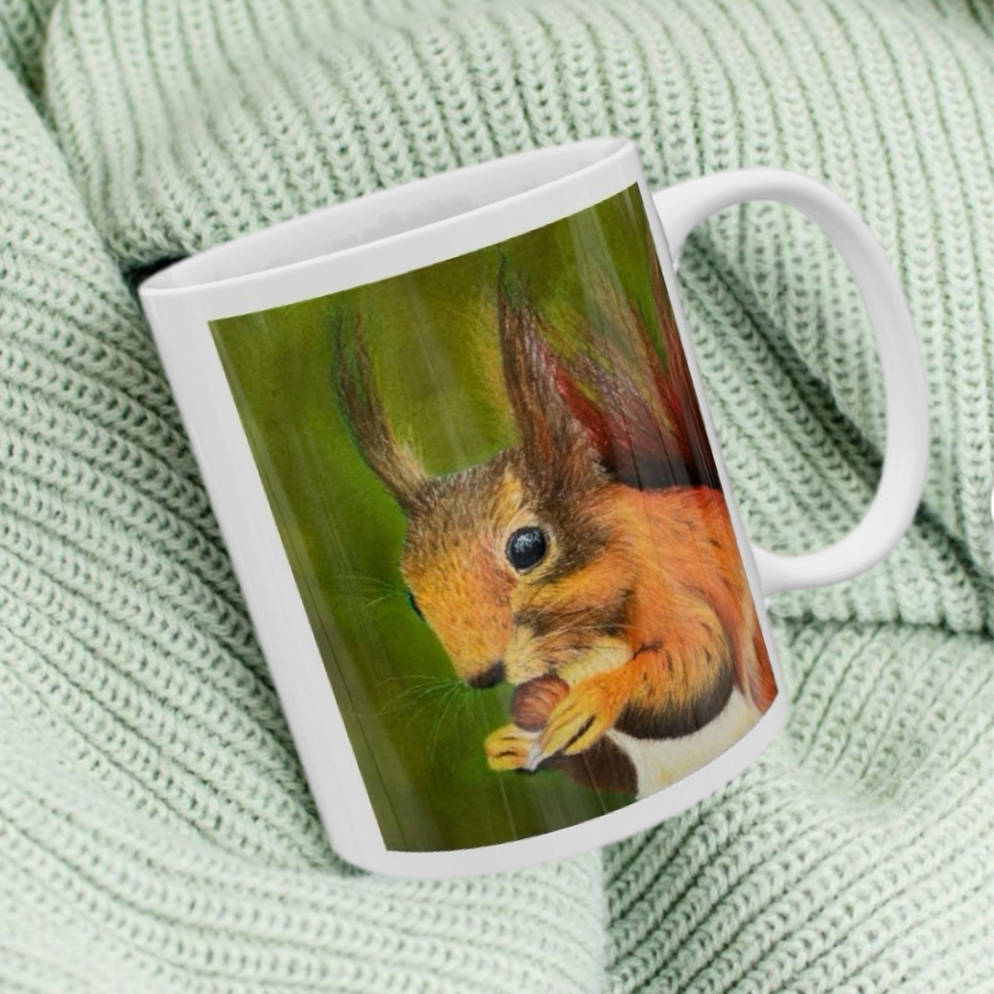 11oz ceramic mug with red squirrel illustration against green woodland background