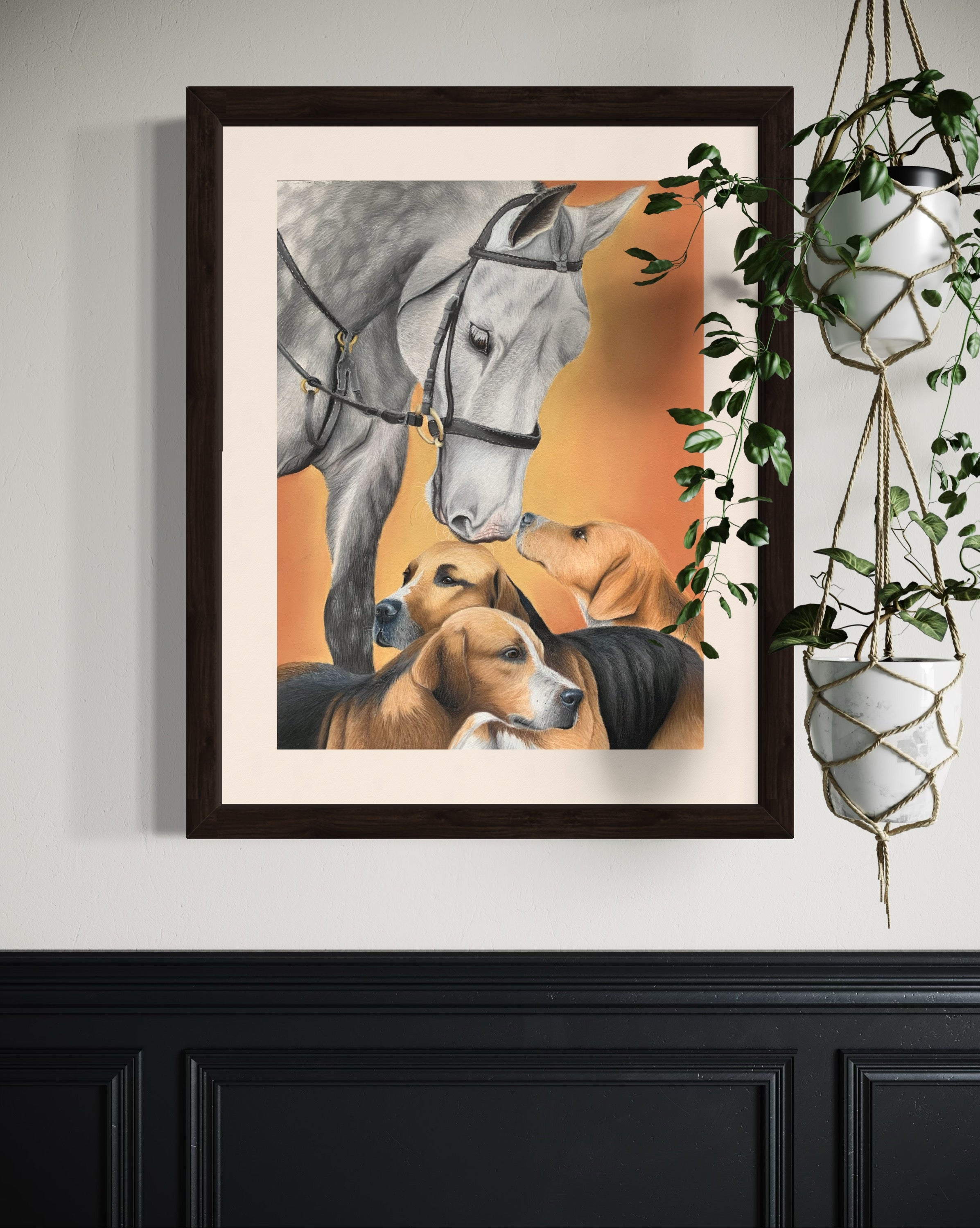 Framed artwork of a horse and three hound dogs on an orange background, hanging on a wall.