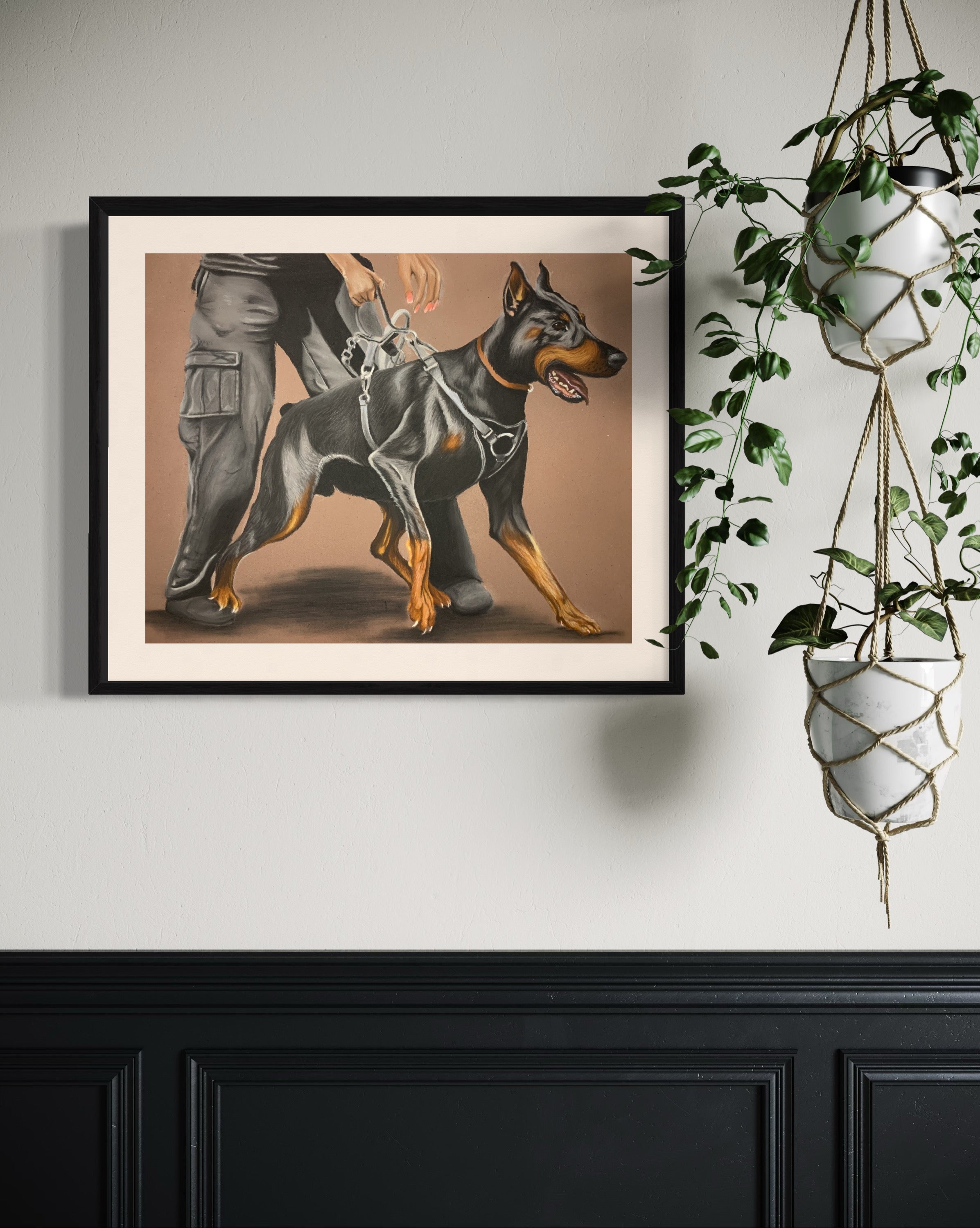 Framed artwork of a female handler holding a large doberman protection dog