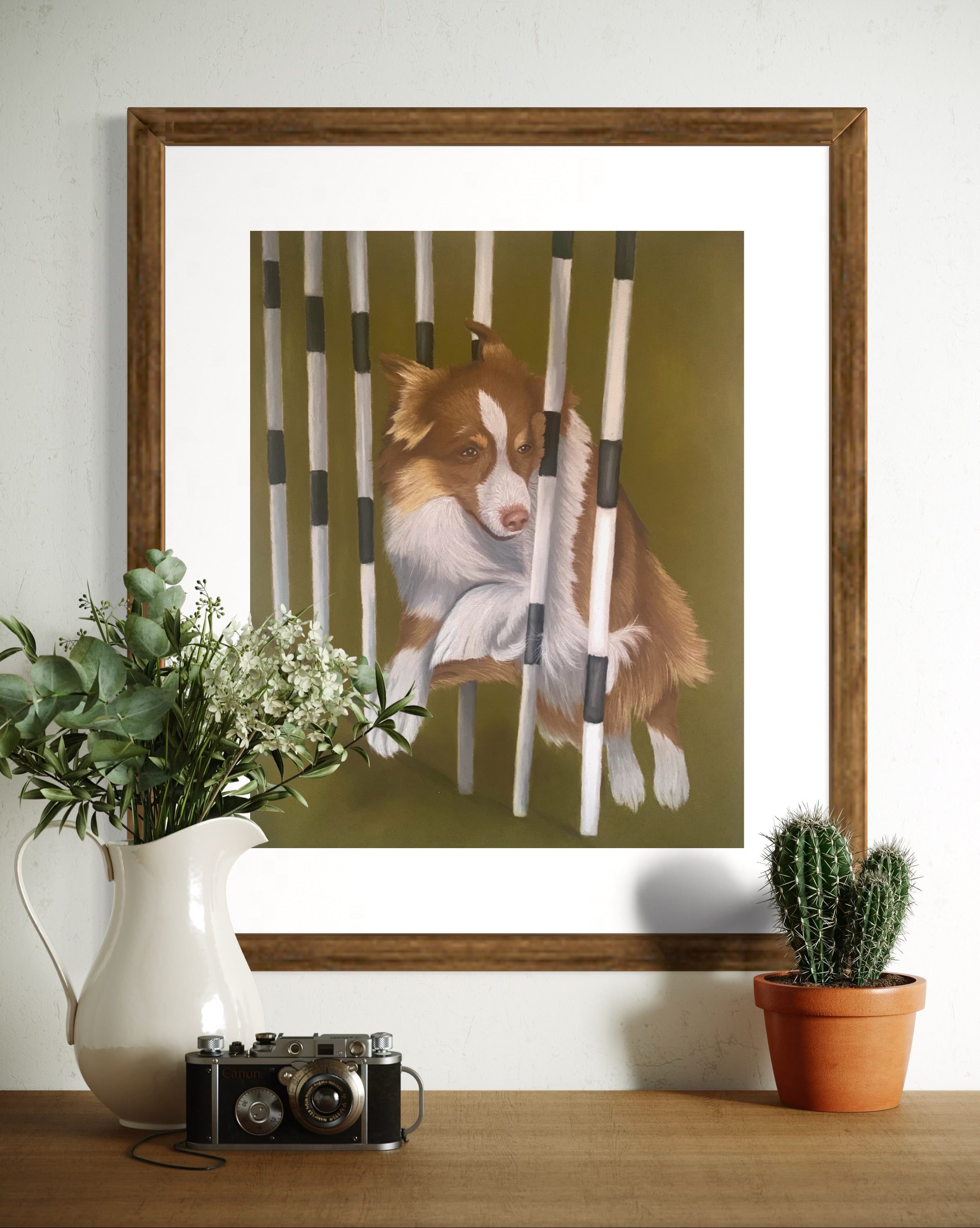 Framed artwork of a border collie weaving through agility weave poles 