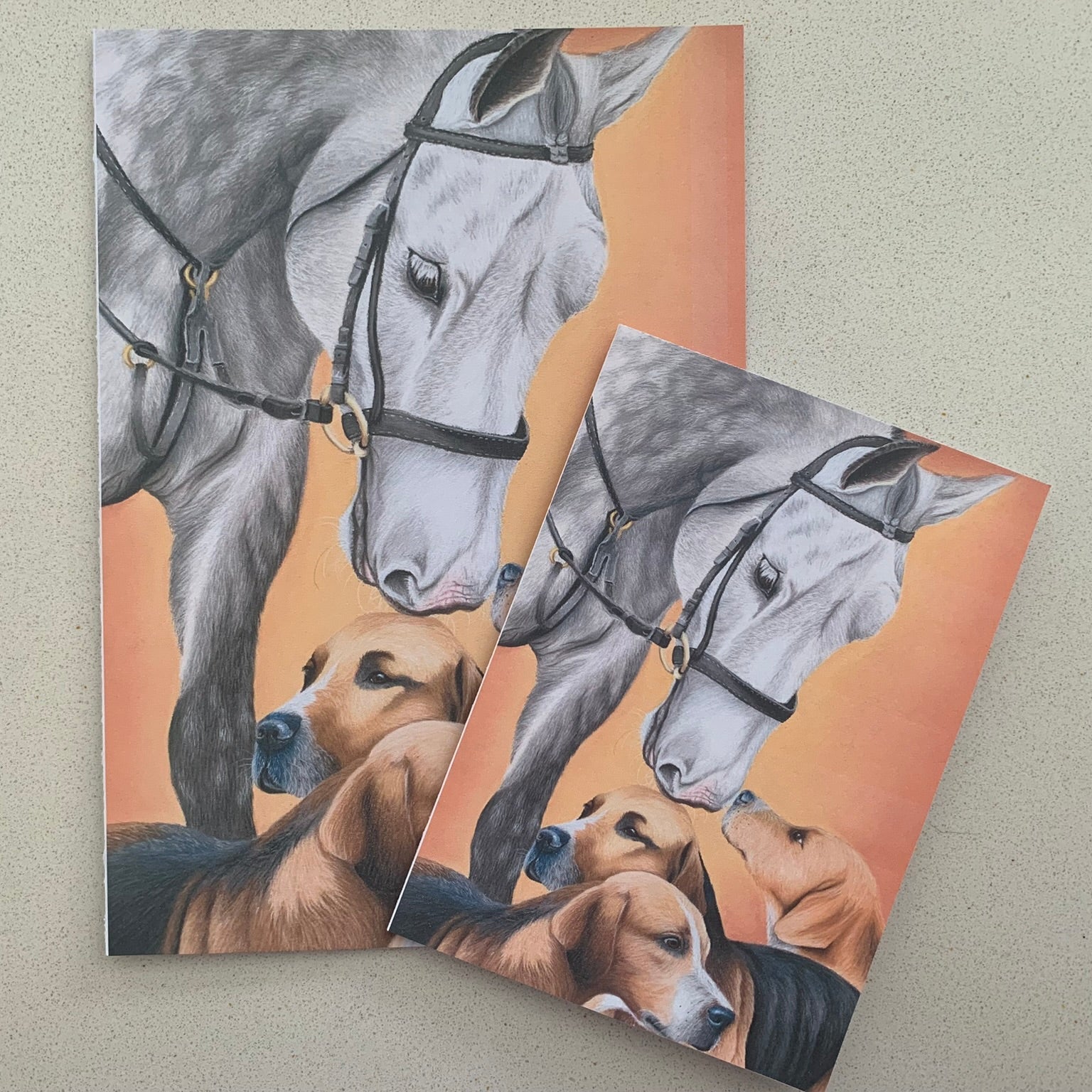 Two cards with a horse and hound dogs illustration on a beige surface